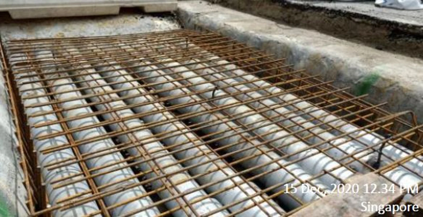 Figure 10: Laying 2 layers of B10 mesh on the steel pipes
