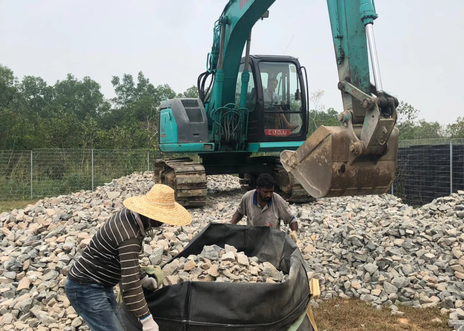 Figure 9: Filling geosynthetic bags with granite